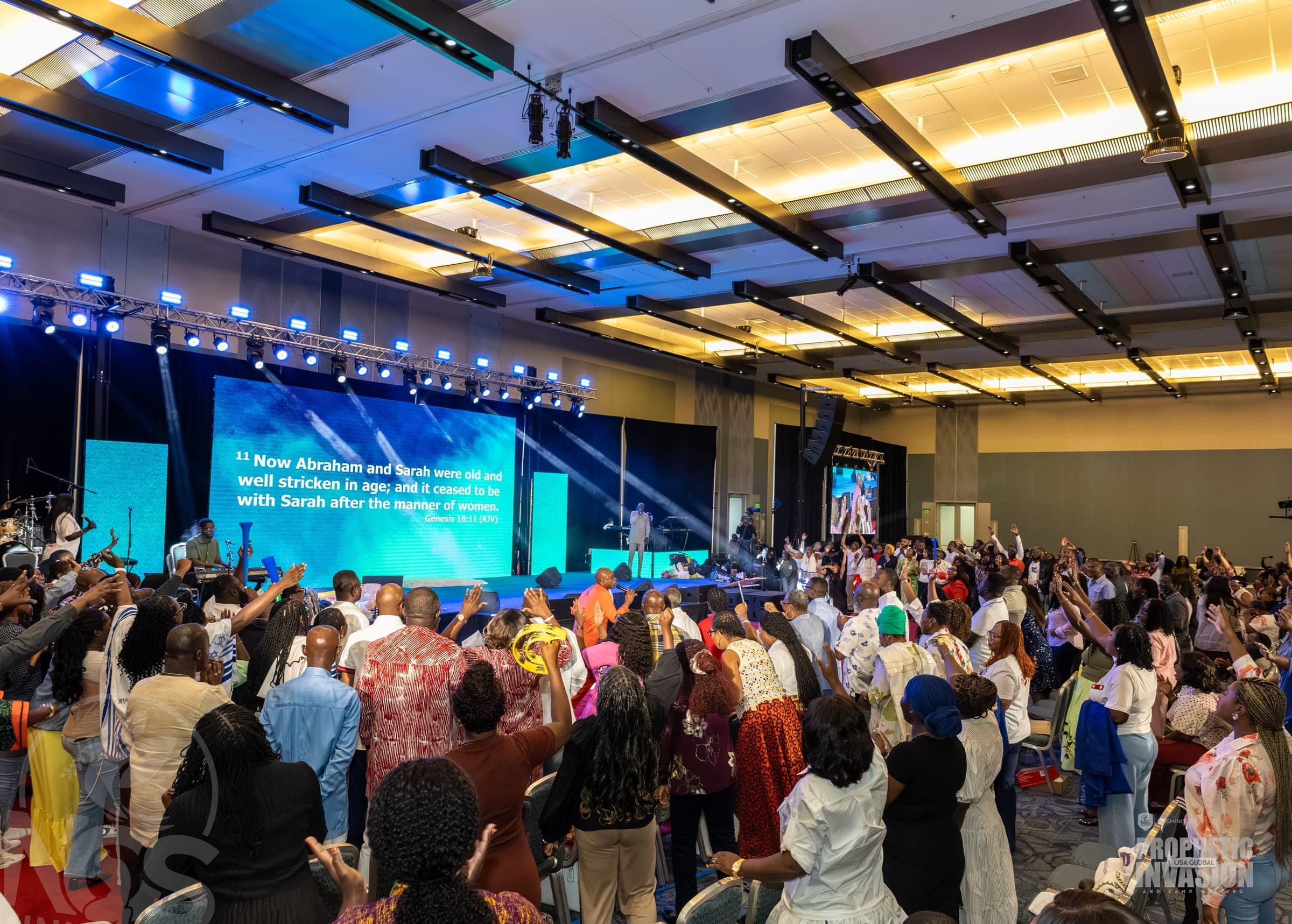 A full convention hall in worship